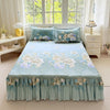Light blue floral print bed skirt set with ruffled hem and decorative pillows displayed in a bright room.