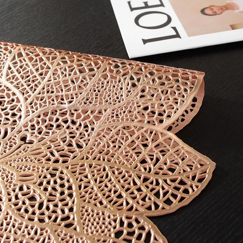 A detailed, intricately cut leaf-shaped placemat or table runner made of light brown, textured material.