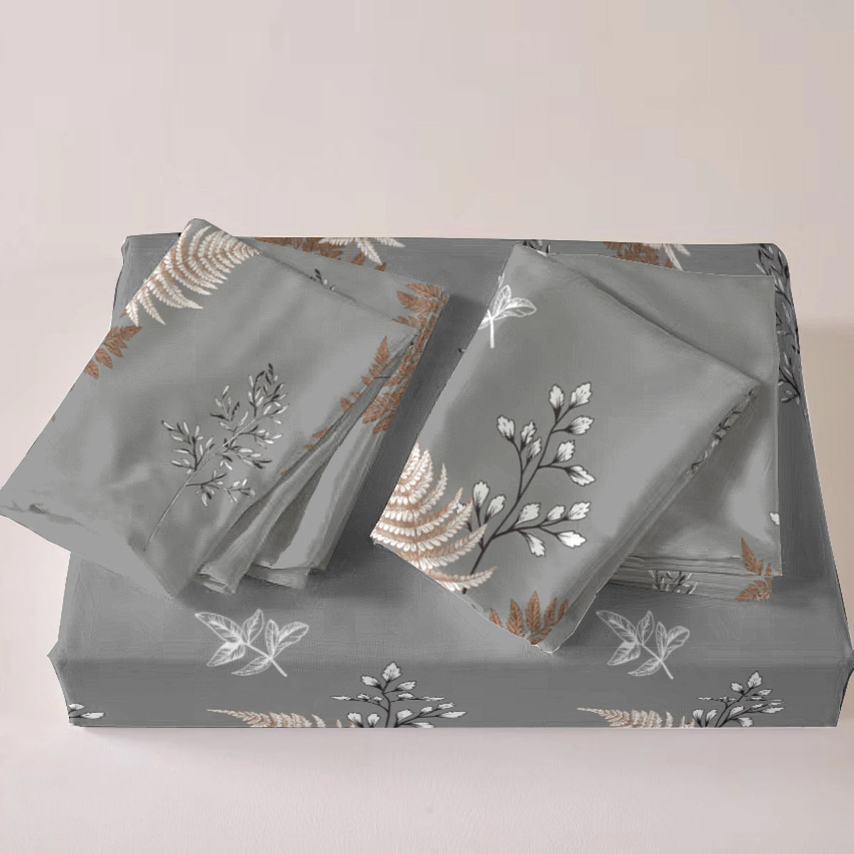 A set of three gray duvet covers featuring a delicate white and gold floral plant print.