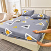 A gray fitted sheet set with yellow geometric patterns and matching pillowcases is displayed on a bed.