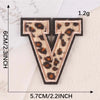 Iron-on patch shaped like the letter V in leopard print on a white fabric background