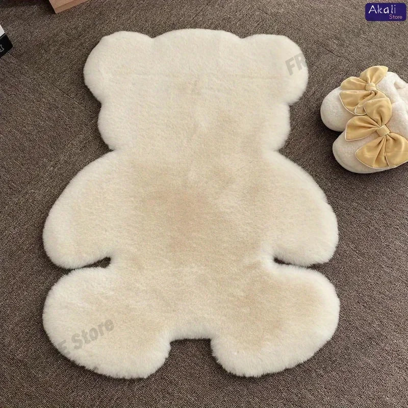A cream-colored plush bear-shaped non-slip area rug lying on a brown carpet.