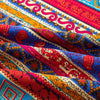 Close-up of colorful bohemian printed linen fabric displaying intricate patterns and vibrant colors.