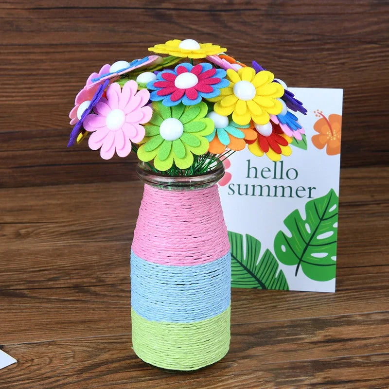 A bouquet of colorful felt flowers in a glass jar with a natural twine wrap, set against a white card.