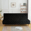 A black velvet non-slip armless sofa cover displayed on a wooden floor with an oriental rug.
