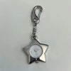 Silver star-shaped pocket watch keychain with a round clock face and adjustable chain.