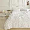 A white duvet cover set displayed on a bed with white wooden paneling and a light rug.