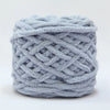 A ball of light gray soft chenille knitting yarn used for hand crafting.