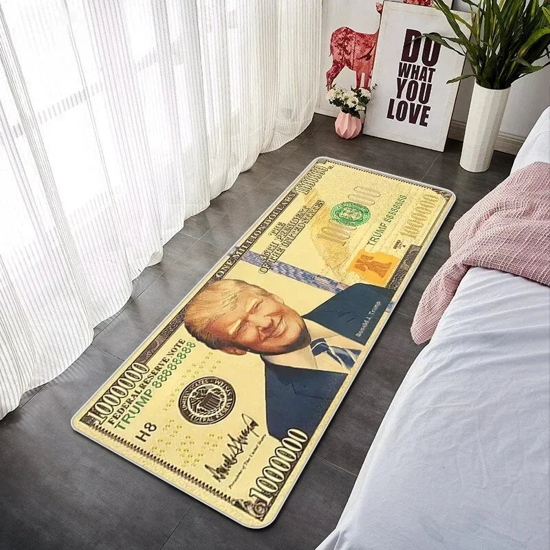A yellow decorative floor mat featuring a portrait of Donald Trump and various currency notes.