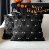 A black faux fur throw pillow cover with white eyes and a pumpkin Halloween theme displayed on a white surface.