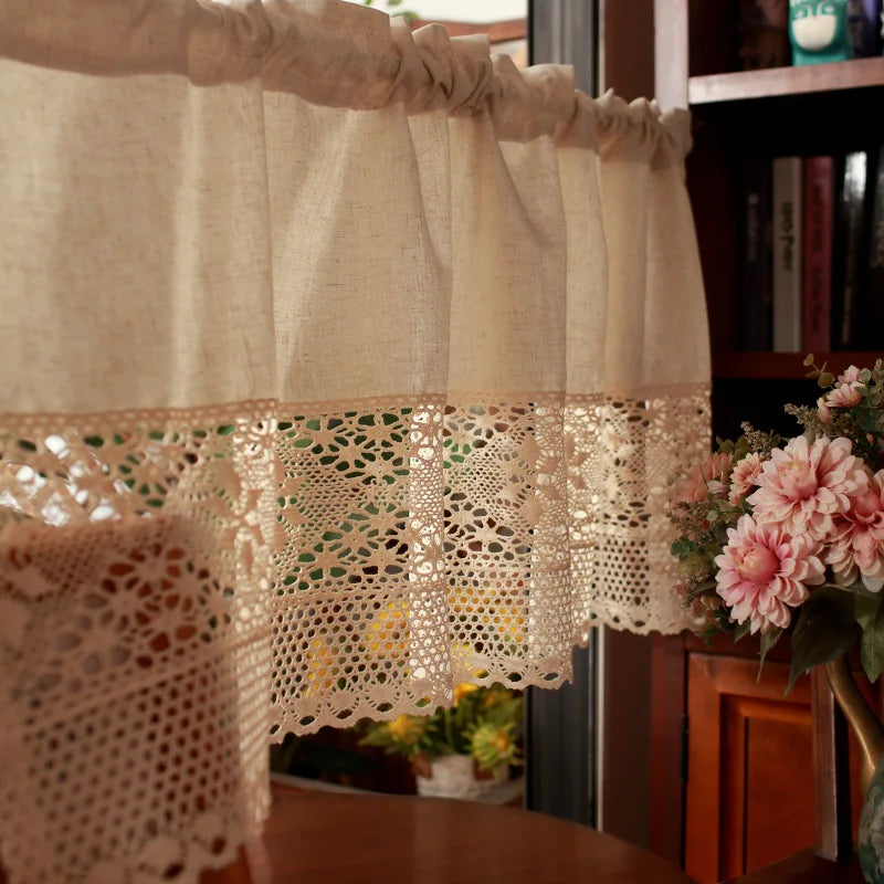 A rustic crochet half curtain made of linen weave with delicate lace trim hanging in a home setting.