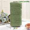 A spool of medium-thick, hand-woven, moss green cotton yarn for crafting.