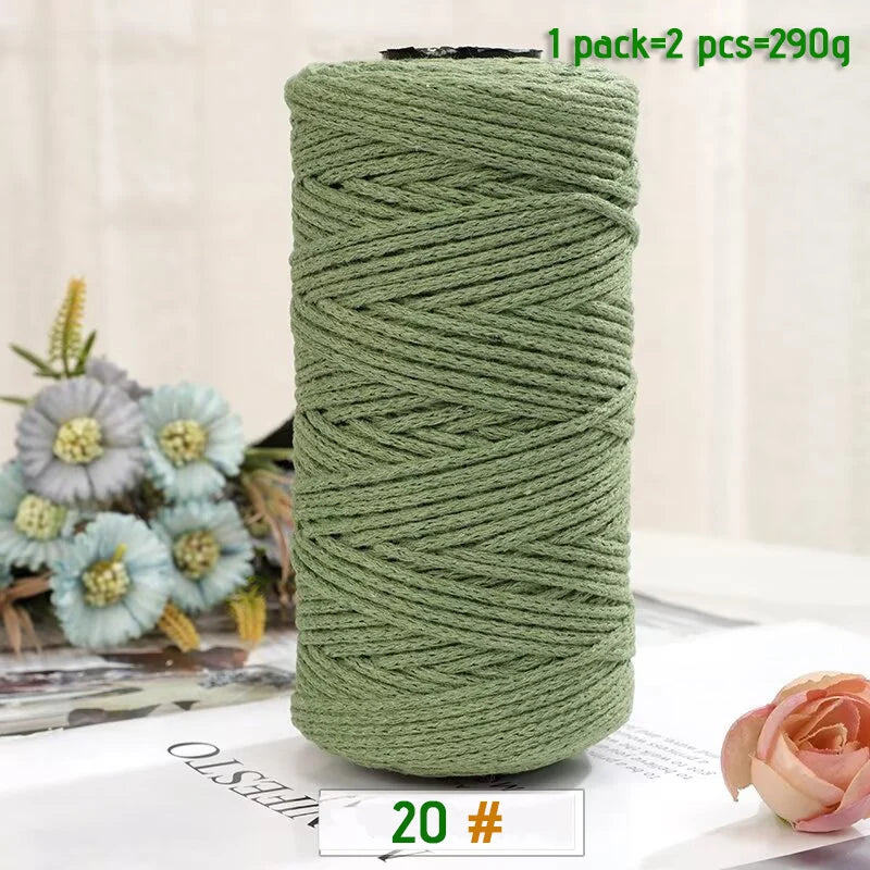 A spool of medium-thick, hand-woven, moss green cotton yarn for crafting.