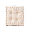 A square, light beige cotton throw pillow with a quilted texture.