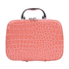 A pink crocodile-textured leather sewing kit with a silver handle.