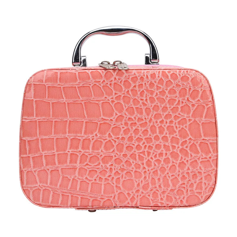A pink crocodile-textured leather sewing kit with a silver handle.