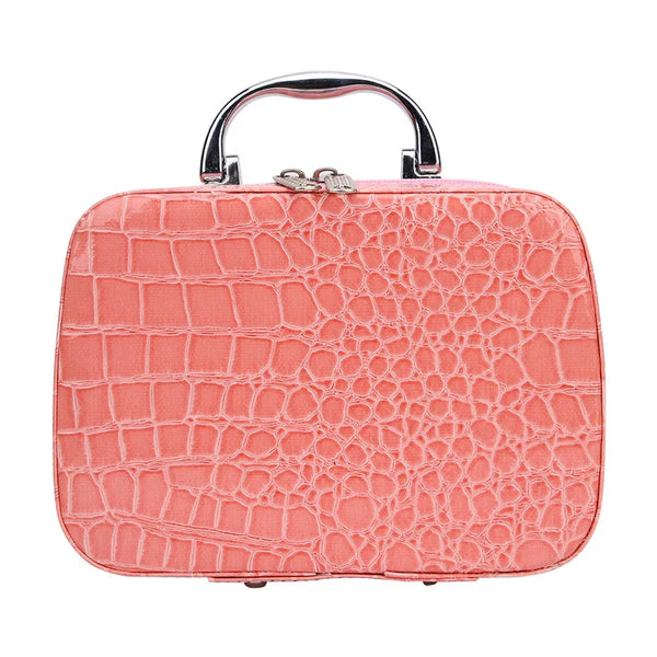 A pink crocodile-textured leather sewing kit with a silver handle.