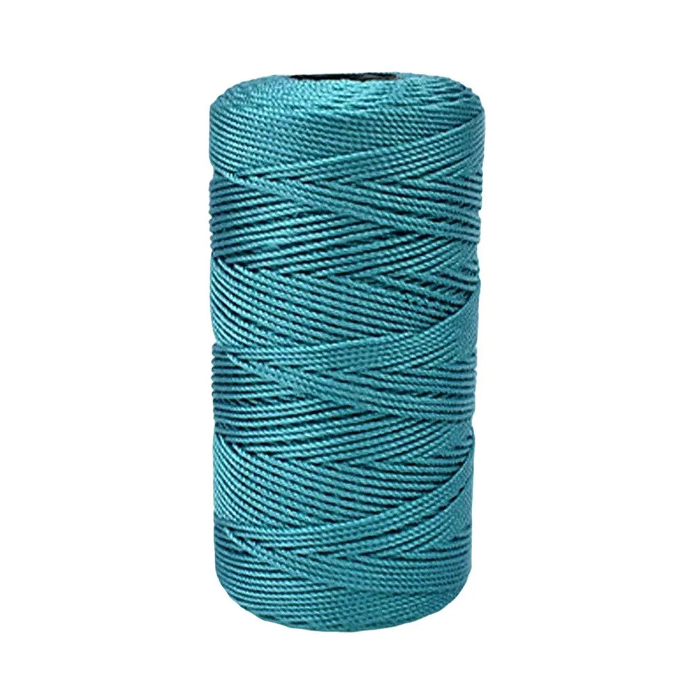 A spool of teal green cotton silk thread for knitting and crafting.