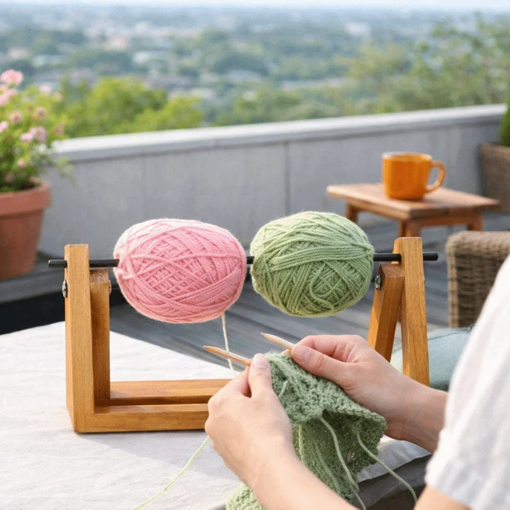 Hands are shown using a yarn to wind it onto a wooden rotating storage rack for handmade yarn.
