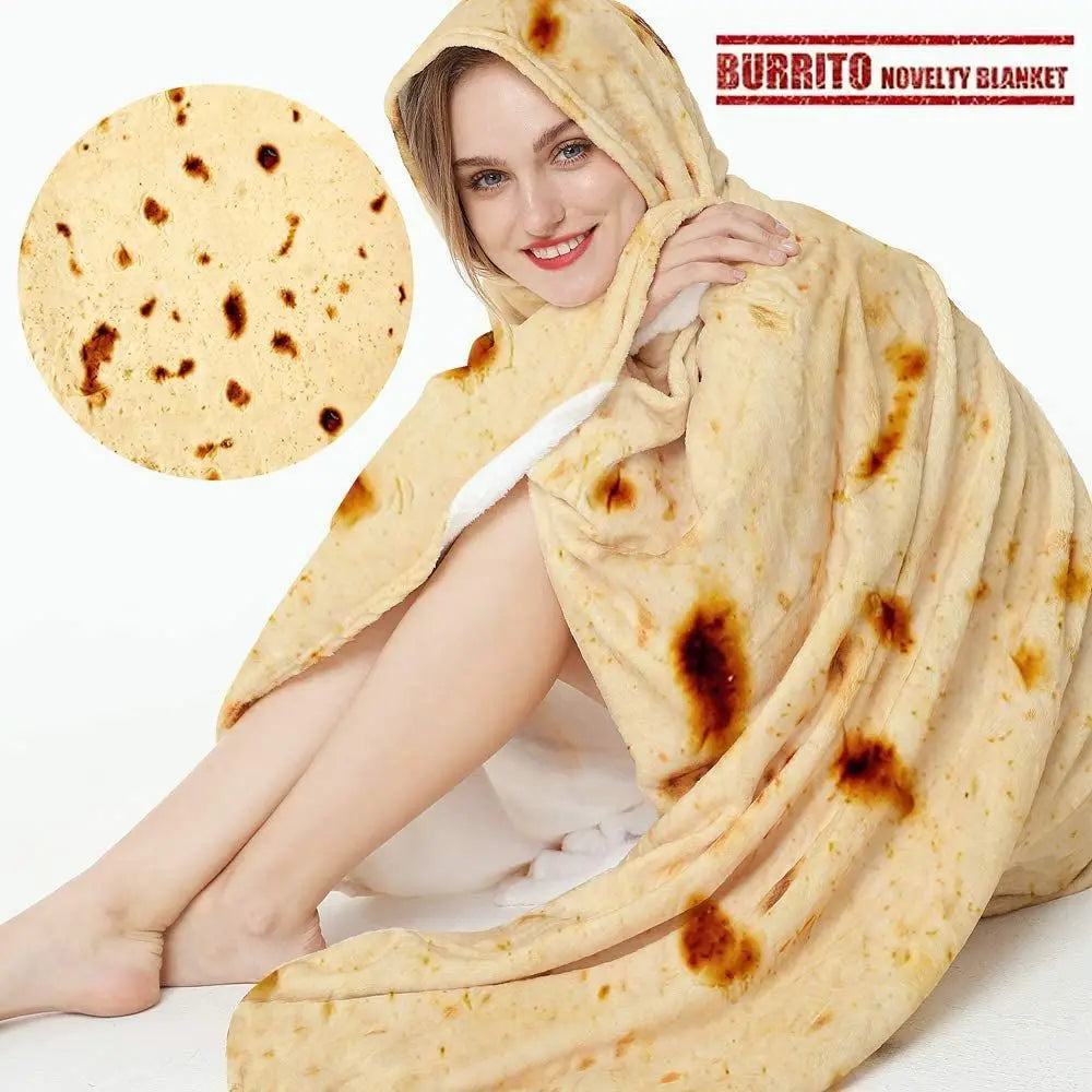 A woman is wrapped in a light yellow burrito blanket throw, sitting down with a tortilla visible nearby.