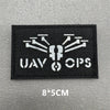 Black embroidered patch with white stylized UAV Ops logo on a gray background