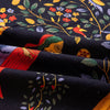 Black linen fabric with a colorful bohemian floral print featuring leaves and a face.