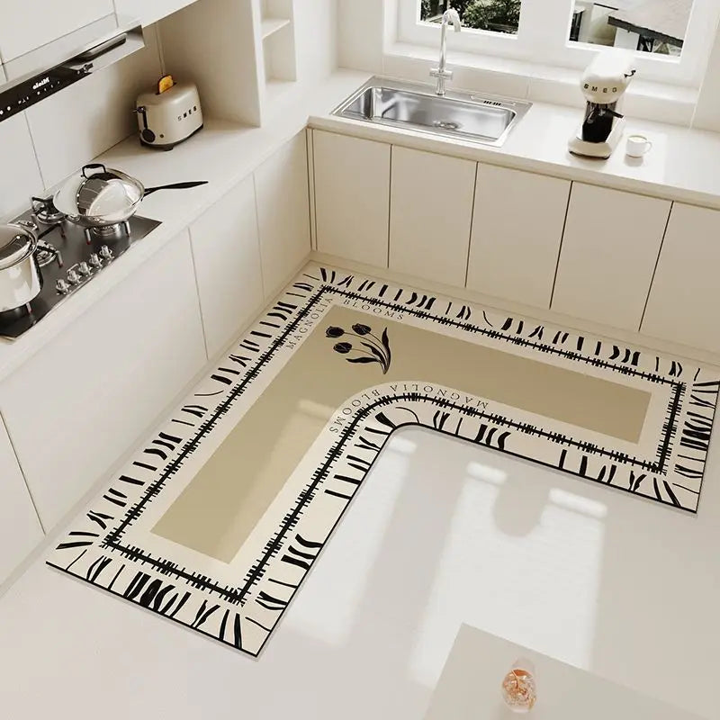 A luxury velvet anti-slip floor mat with a black and white patterned border is displayed on a white kitchen countertop.