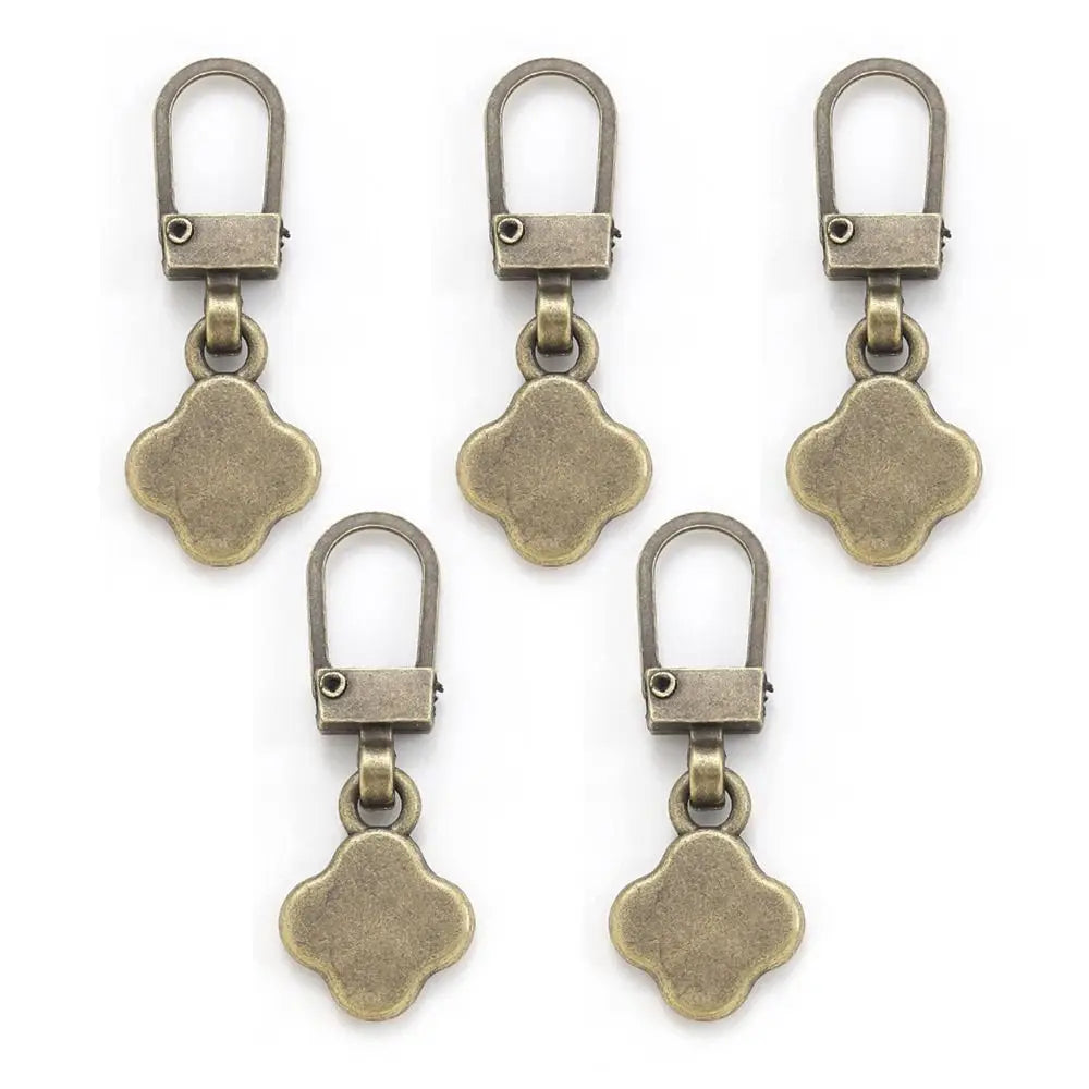 A set of five antique brass metal zipper pull replacement kits with oval-shaped charms.