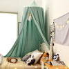 A light teal princess hanging bed canopy with sheer fabric and decorative elements in a bright room.