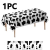 One piece of cow print disposable plastic tablecloth displayed on a surface.