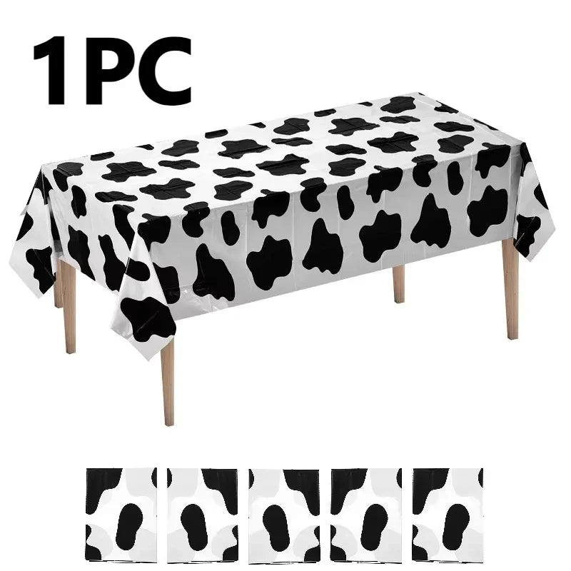 One piece of cow print disposable plastic tablecloth displayed on a surface.