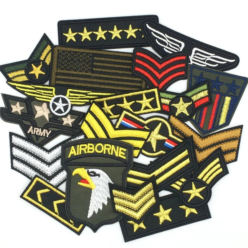 A collection of embroidered tactical clothing patches featuring military insignia and emblems.
