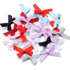 A collection of colorful satin ribbon bows in various shades including red, pink, blue, purple, and gray.