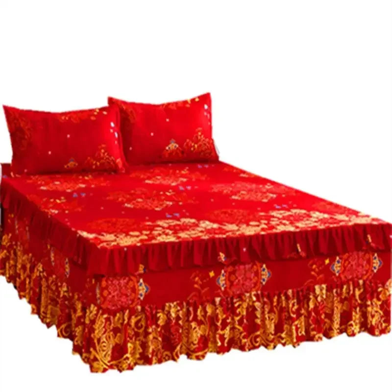A set of three red fitted bed sheets with elastic lace trim displayed on a bed.
