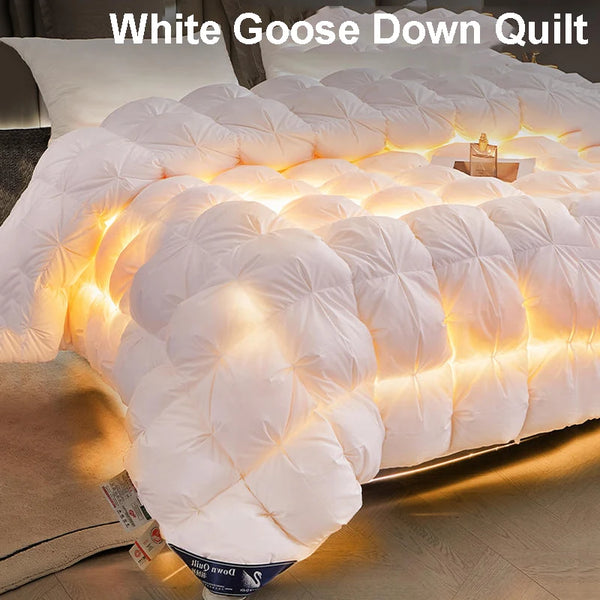 A white goose down quilt is displayed on a bed, showing its fluffy texture and illuminated quilting pattern.