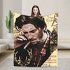 A woman holds up a large print featuring a portrait of Arthur Morgan in a plaid shirt.