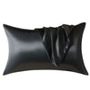 Black satin pillow with draped fabric detail