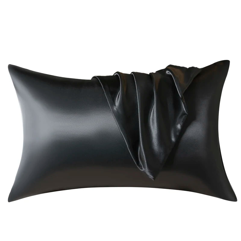 Black satin pillow with draped fabric detail
