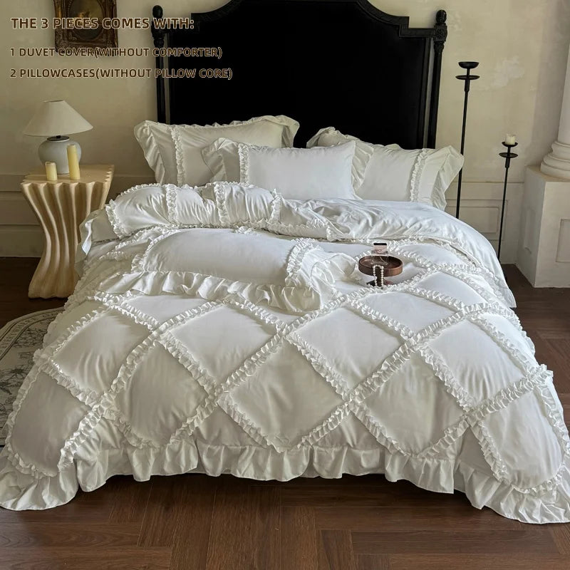 A white ruffled duvet cover set with pillowcases and a pillow core displayed on a bed.