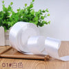Roll of white satin ribbon for gift wrapping and DIY crafts