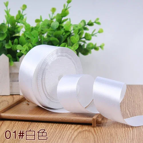 Roll of white satin ribbon for gift wrapping and DIY crafts