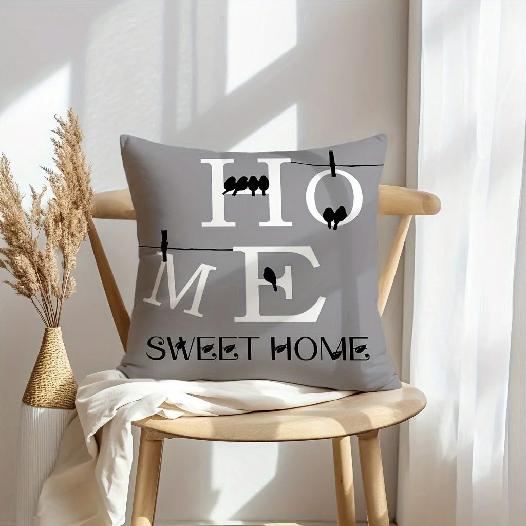 A gray pillow with the text HOME and SWEET HOME in white lettering, displayed on a wooden chair.