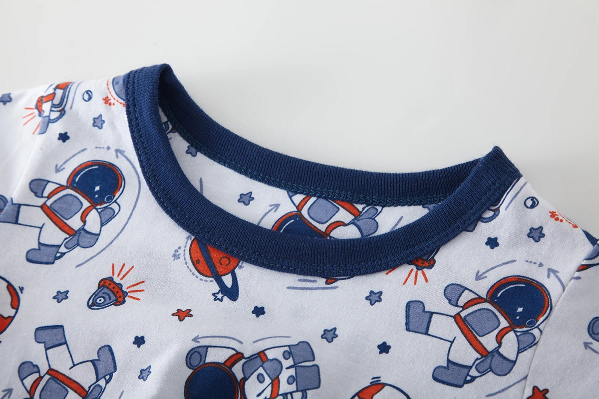 White cartoon astronaut pajama set for kids with blue and orange accents