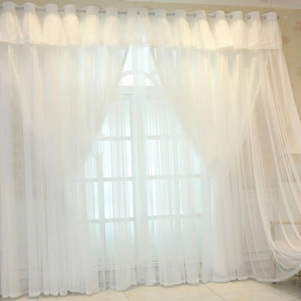 White sheer double-layer curtains covering a window with a geometric frame.