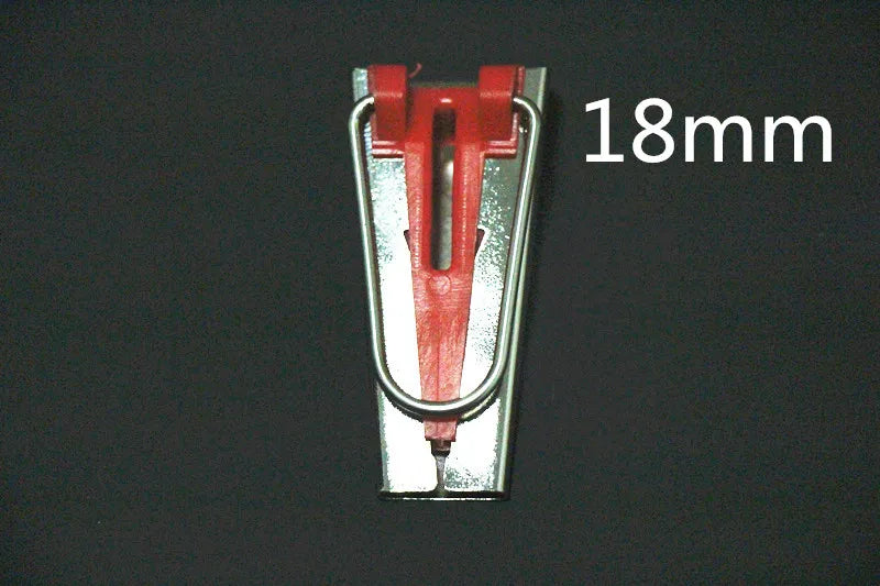 A close-up view of a red and silver precision bias tape maker tool with an 18mm measurement mark.