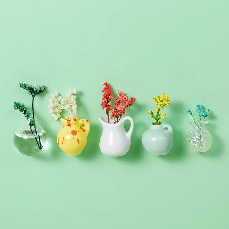 A collection of mini ceramic landscape fridge magnets featuring various plant and floral designs in yellow, white, and red on
