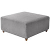A square ottoman covered in a textured gray stretch jacquard fabric.