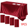 A deep red satin rectangle tablecloth displayed with silverware and wine glasses, along with several matching cylindrical fab