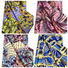 A collection of vibrant African wax print fabric patterns featuring floral and botanical designs in purple, yellow, pink, and