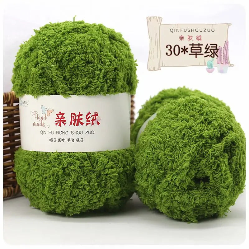 Two balls of bright green mossy yarn labeled as Soft Coral Velvet Yarn for Crafting with a pink cactus decoration.